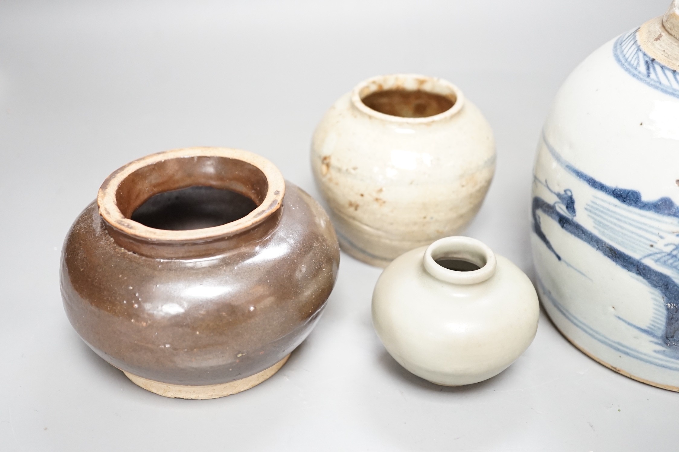 A Chinese celadon jarlet, Yuan-Ming Dynasty, two provincial stoneware jars and a 19th century Chinese provincial blue and white jar, tallest 16cm